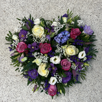 Lilac heart tribute - Pretty heart tribute designed with a mix of pink and lilac seasonal flowers