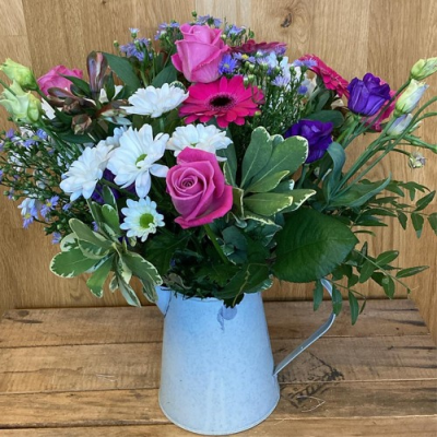Just Picked - A charming jug arrangement. Includes a mix of pink, white and purple flowers with complimentary foliage. Hand delivered with care in and around Dereham by Bright and Beautiful.