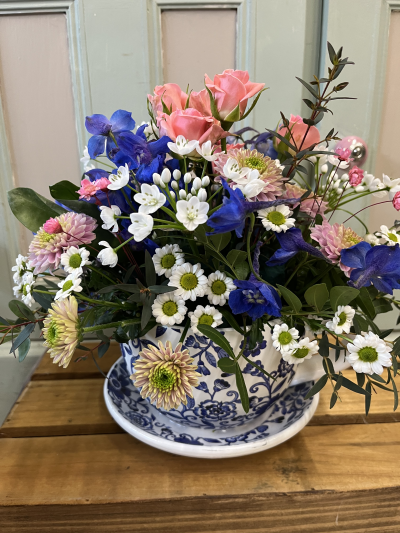 Time for tea - Tea cup with flowers arranged delivered, pretty shades, pink, blue, lilac, white.