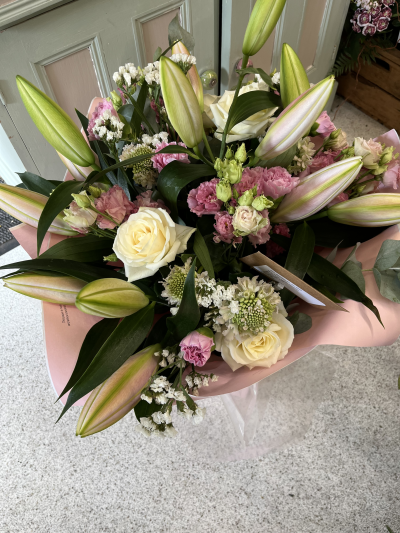 The sweet surprise - This a mix of pink and white flowers including Lilies, roses, eustoma, statice and eucalyptus. Presented in a pink box. For delivery or collection.